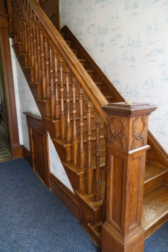 Polished wooden staircase and banister inside the farmhouse