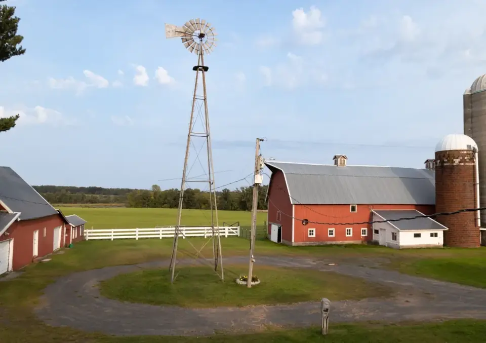 Old windmill above the red barns and silos at Longview Farm